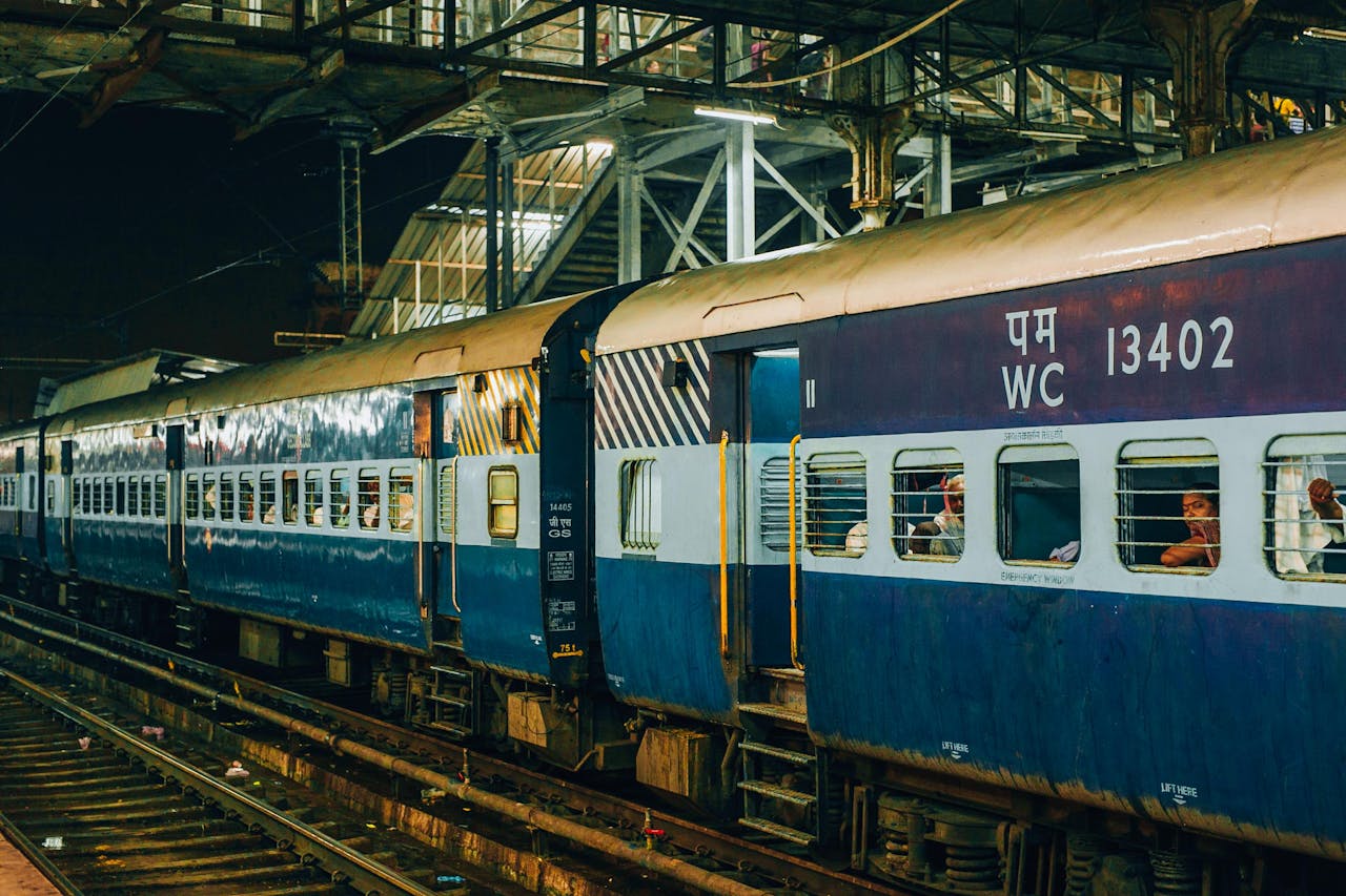 A train at a bustling railway station at night, capturing urban transportation.